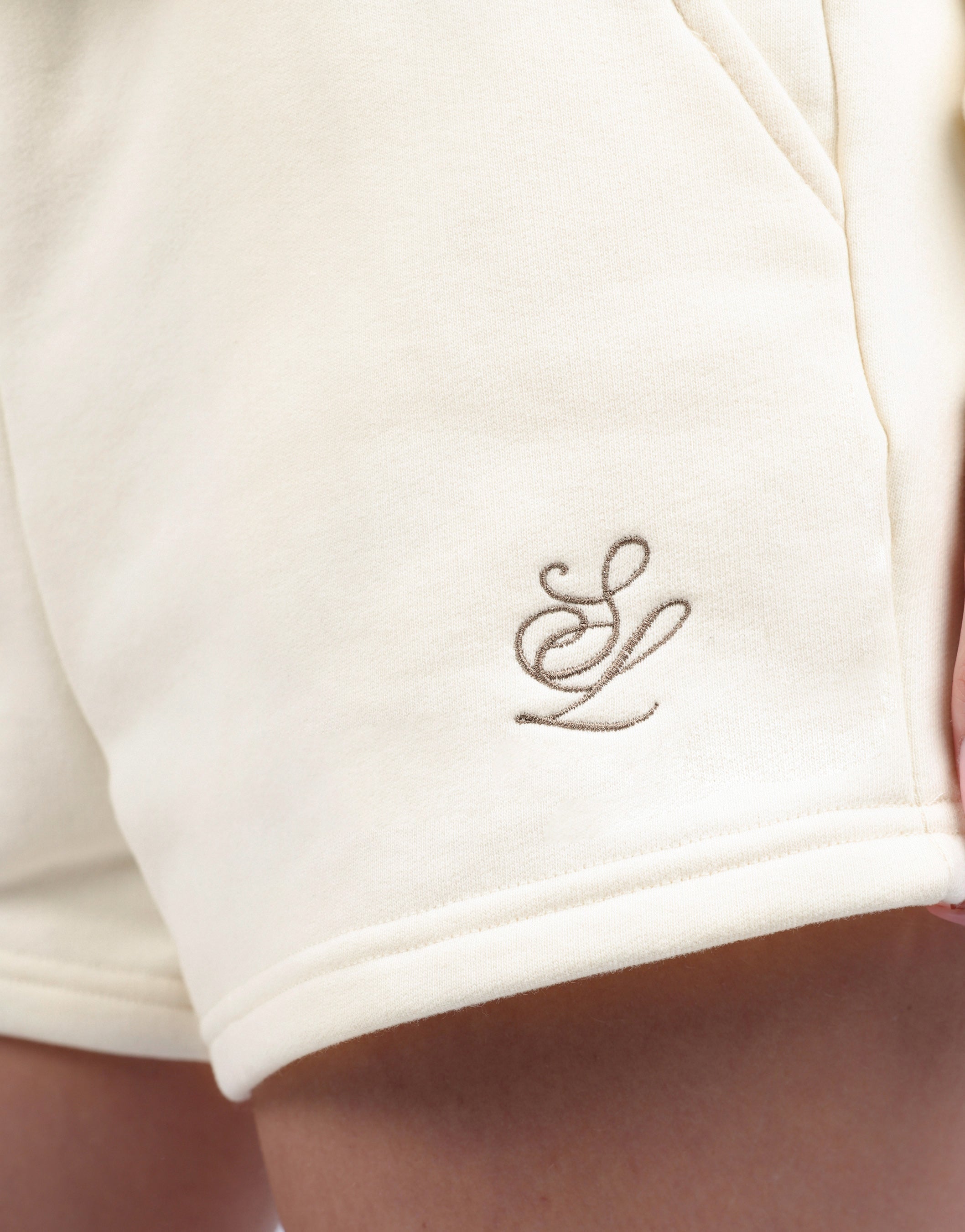 Riva Simmi Studios Embroidered Logo Shorts In Cream
